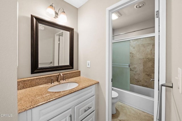 full bathroom featuring vanity, tiled shower / bath combo, tile patterned floors, and toilet