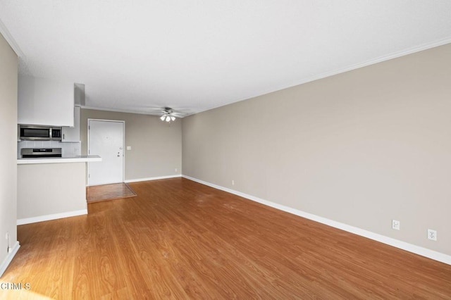 unfurnished living room featuring hardwood / wood-style flooring and ceiling fan