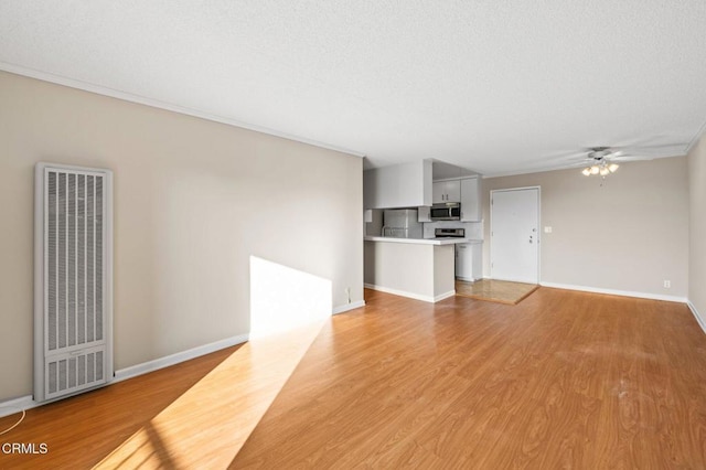 unfurnished living room with a textured ceiling, ceiling fan, and light hardwood / wood-style flooring