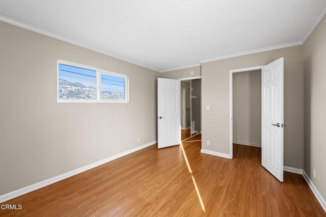 unfurnished bedroom with wood-type flooring and ornamental molding