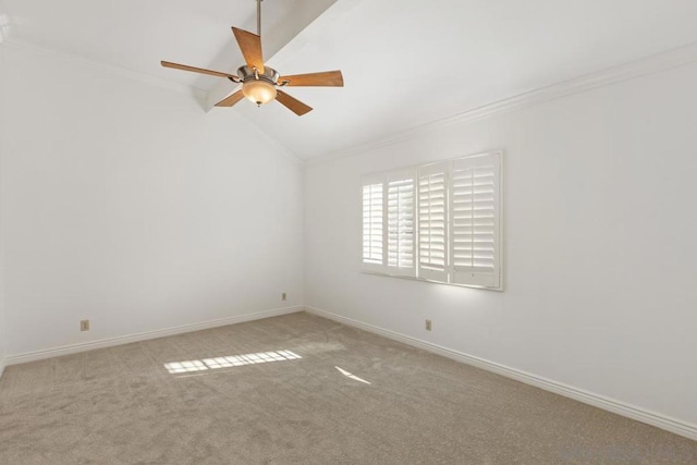 carpeted empty room featuring crown molding, lofted ceiling, and ceiling fan