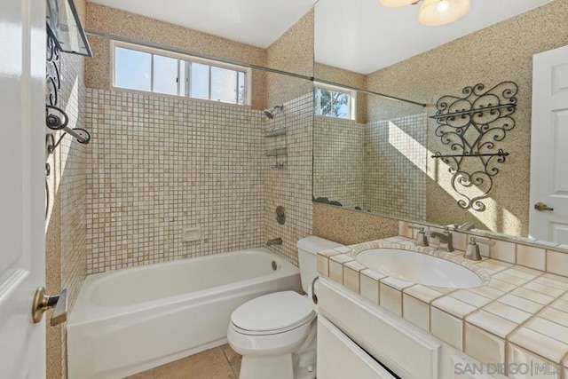 full bathroom with tiled shower / bath, vanity, toilet, and tile patterned flooring