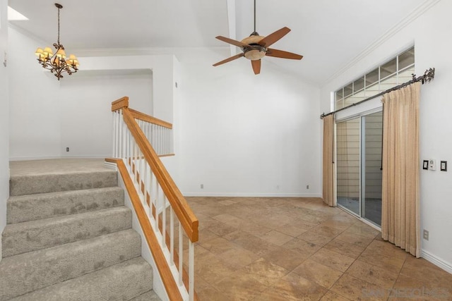 staircase featuring ornamental molding, lofted ceiling, and ceiling fan with notable chandelier