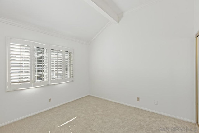 empty room featuring light carpet, crown molding, and lofted ceiling with beams