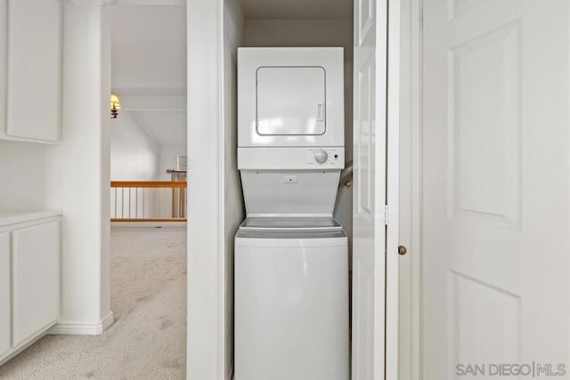 laundry room with stacked washer / dryer and light carpet