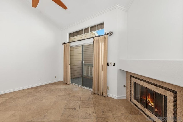 unfurnished living room featuring ceiling fan, ornamental molding, a tiled fireplace, and vaulted ceiling