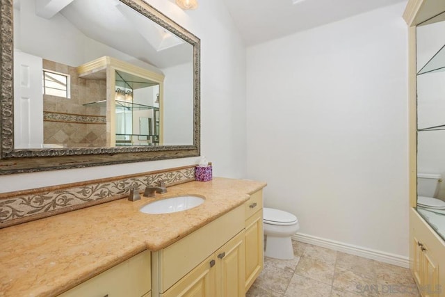 bathroom with vanity, toilet, and a tile shower