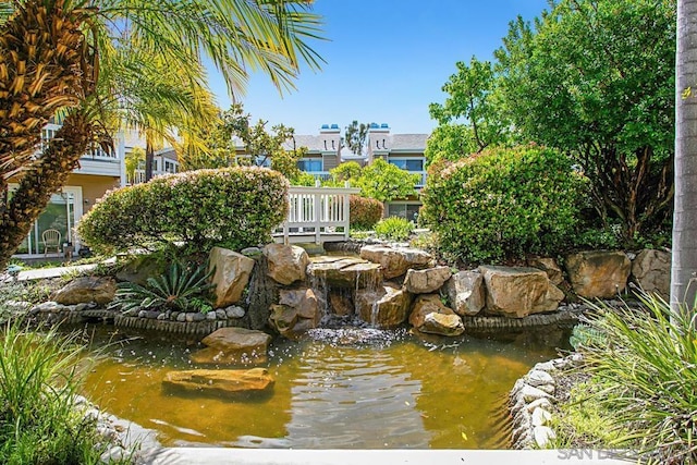 view of home's community with a small pond