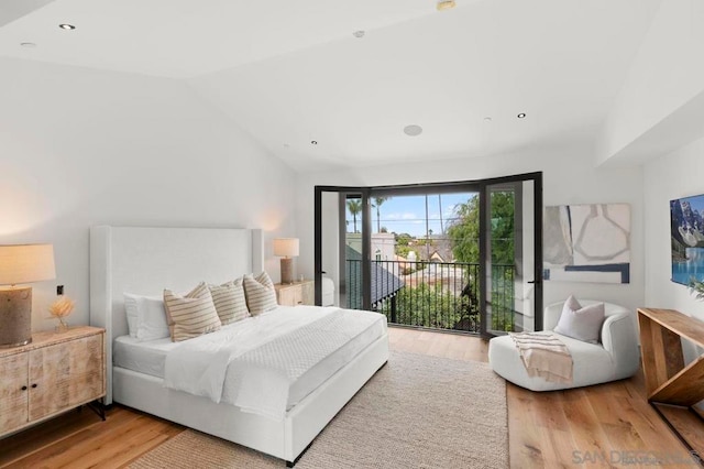 bedroom featuring vaulted ceiling, access to exterior, and light hardwood / wood-style flooring