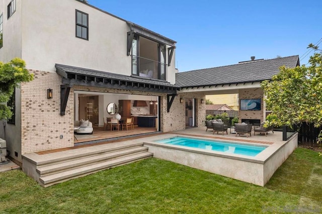 back of property with a balcony, a yard, an outdoor hangout area, and a patio