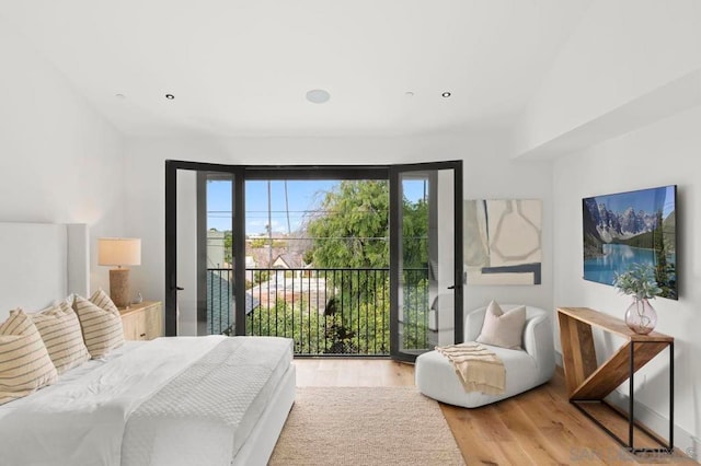 bedroom featuring access to outside and wood-type flooring