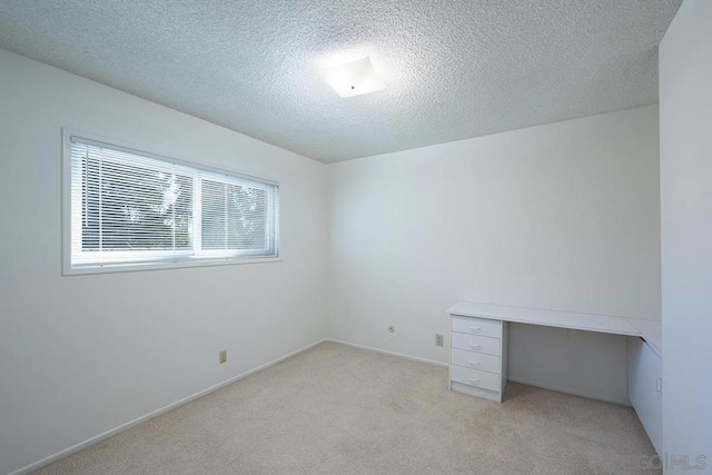 carpeted spare room with a textured ceiling