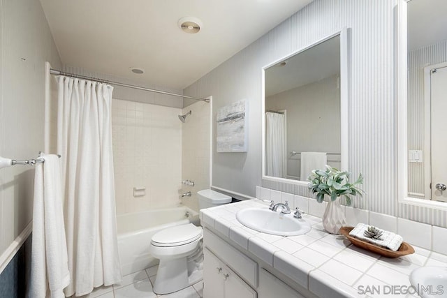 full bathroom with shower / bathtub combination with curtain, vanity, tile patterned flooring, and toilet