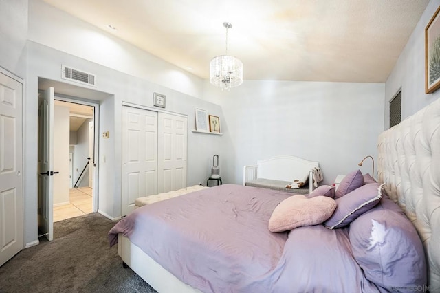 carpeted bedroom with a chandelier and a closet