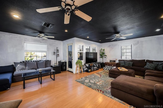 living room with hardwood / wood-style flooring and a textured ceiling