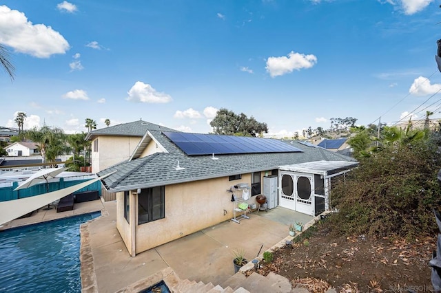 rear view of property featuring a patio and a sunroom