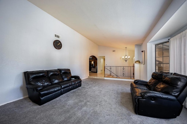 carpeted living room with vaulted ceiling and a notable chandelier