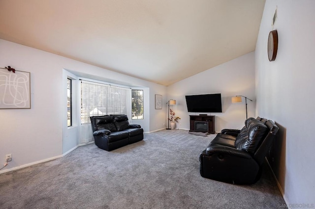 carpeted living room featuring vaulted ceiling