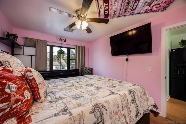 bedroom with wood-type flooring and ceiling fan