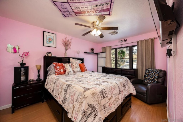 bedroom with ceiling fan and light hardwood / wood-style flooring