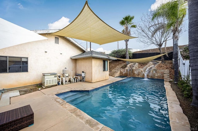 view of pool with pool water feature and a patio area