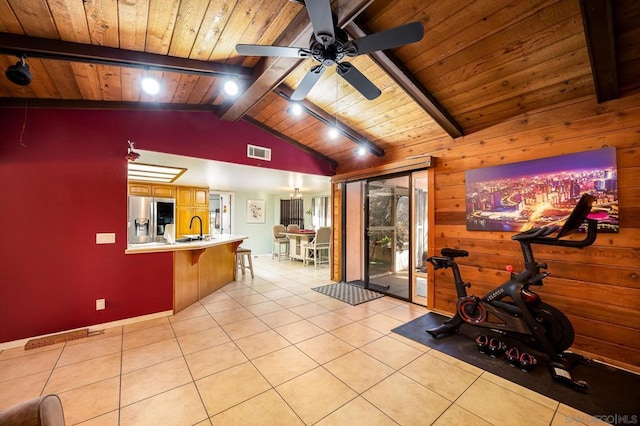 workout area featuring lofted ceiling, sink, wooden ceiling, and light tile patterned flooring