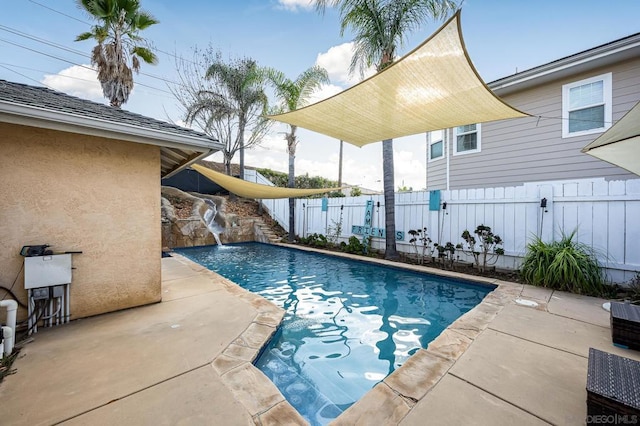 view of pool featuring pool water feature and a patio