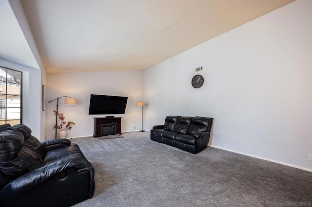 carpeted living room with vaulted ceiling