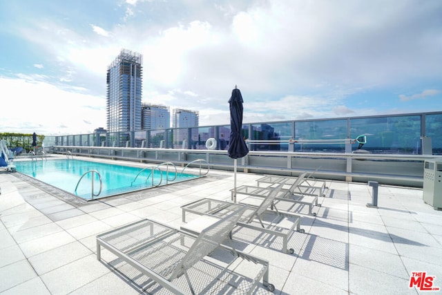 view of swimming pool featuring a patio area