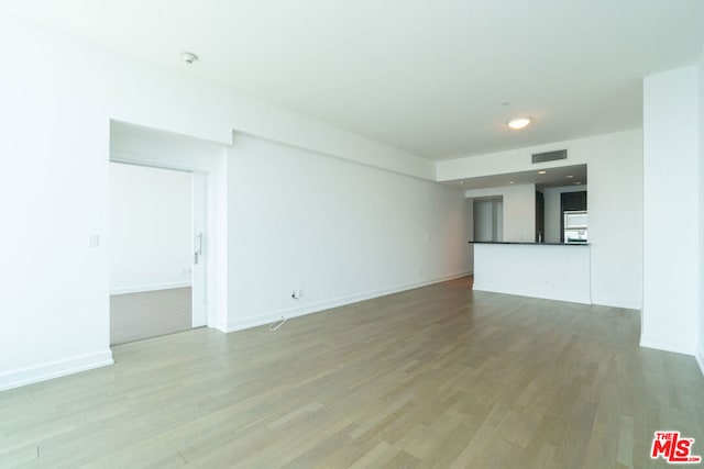 unfurnished living room with hardwood / wood-style flooring