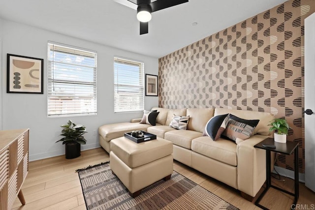 living room featuring light hardwood / wood-style flooring and ceiling fan