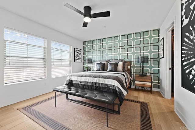 bedroom with hardwood / wood-style floors and ceiling fan