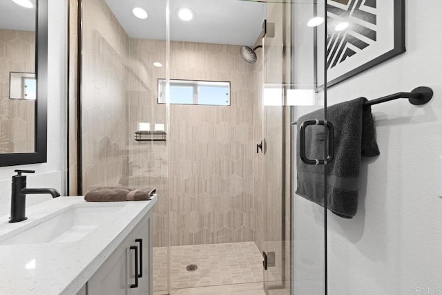 bathroom with vanity and a shower with shower door