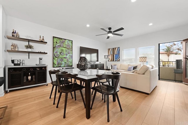 dining area with ceiling fan and light wood-type flooring