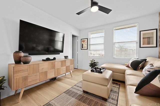 living room featuring ceiling fan and light wood-type flooring