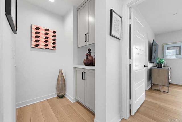 corridor with light hardwood / wood-style floors