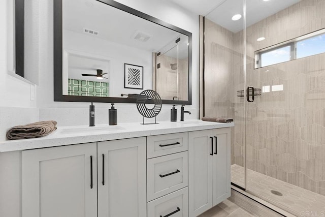 bathroom with vanity and a shower with shower door