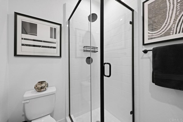 bathroom featuring toilet and walk in shower