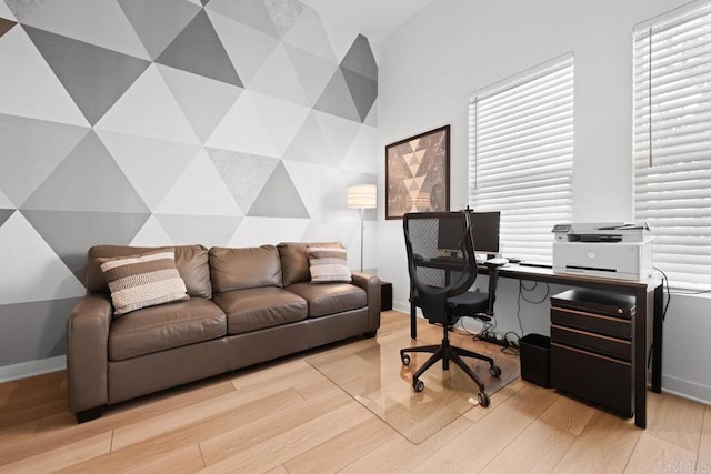 home office with light hardwood / wood-style floors