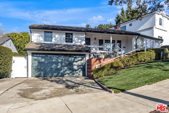 front facade featuring a porch, a garage, and a front yard