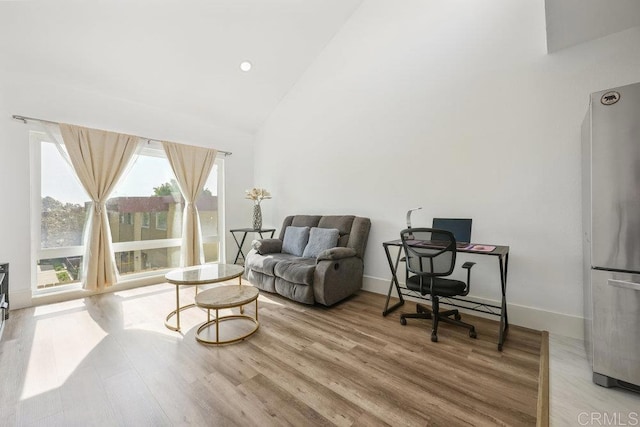 office area featuring high vaulted ceiling and light hardwood / wood-style floors