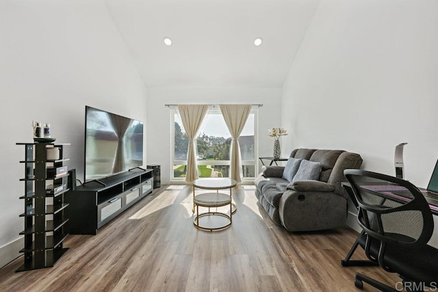 living room featuring high vaulted ceiling and hardwood / wood-style floors