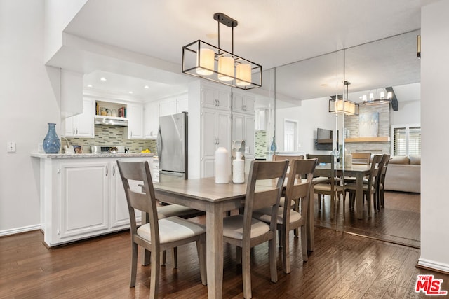 dining area with dark hardwood / wood-style floors