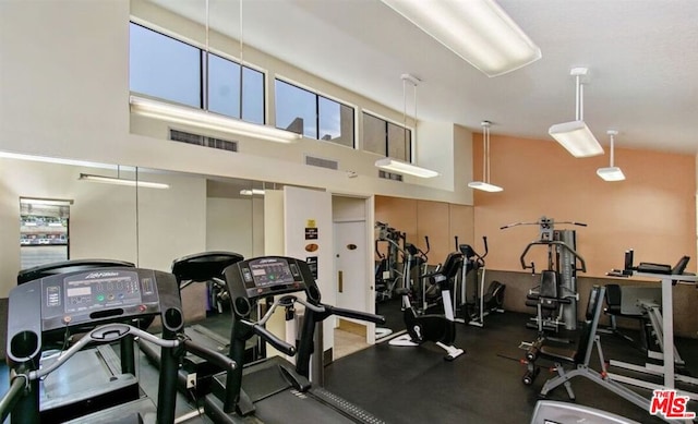 workout area with high vaulted ceiling