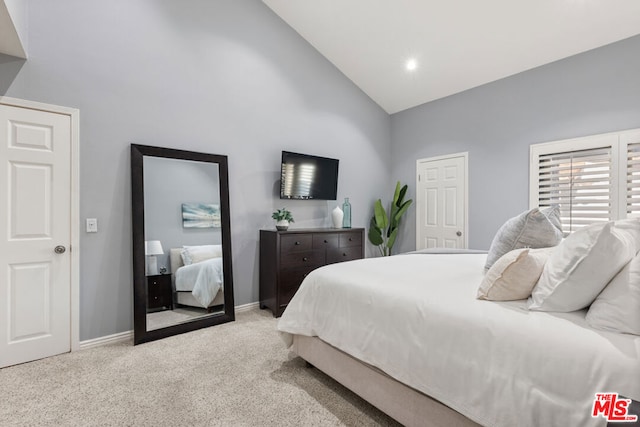 carpeted bedroom featuring high vaulted ceiling