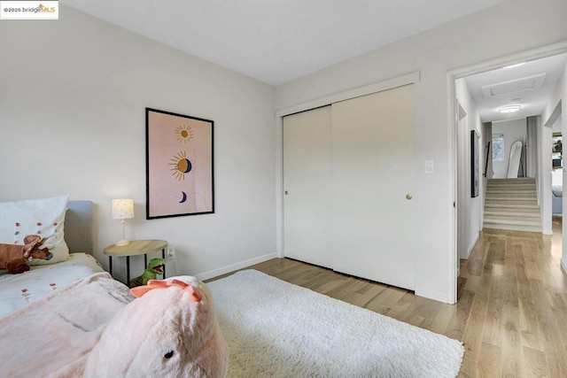 bedroom featuring light hardwood / wood-style flooring and a closet