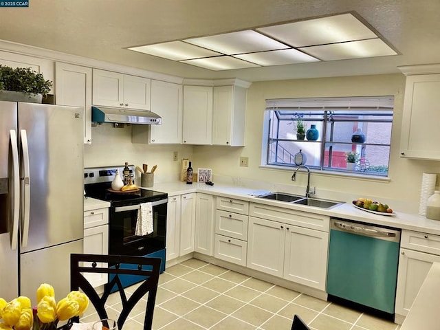 kitchen with sink, stainless steel appliances, white cabinets, and light tile patterned flooring