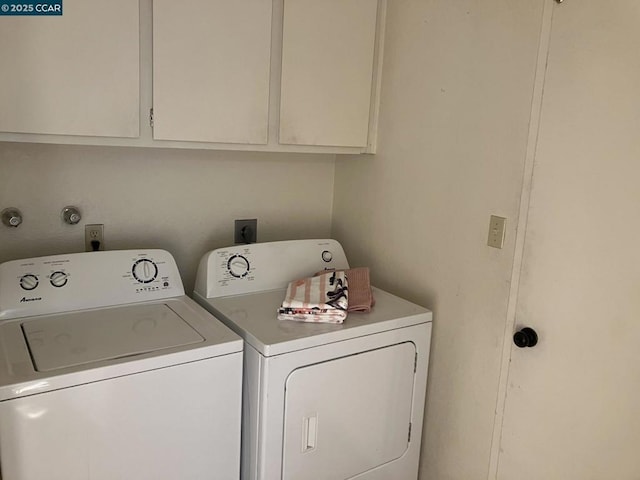 washroom with separate washer and dryer and cabinets