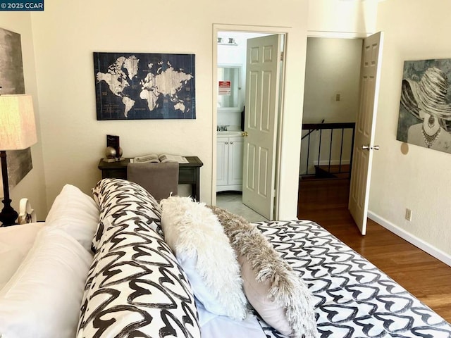 bedroom with sink, hardwood / wood-style floors, and ensuite bath