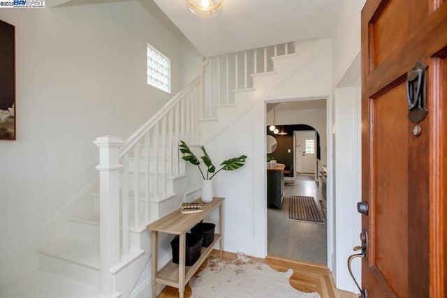 entrance foyer featuring a towering ceiling and light hardwood / wood-style flooring